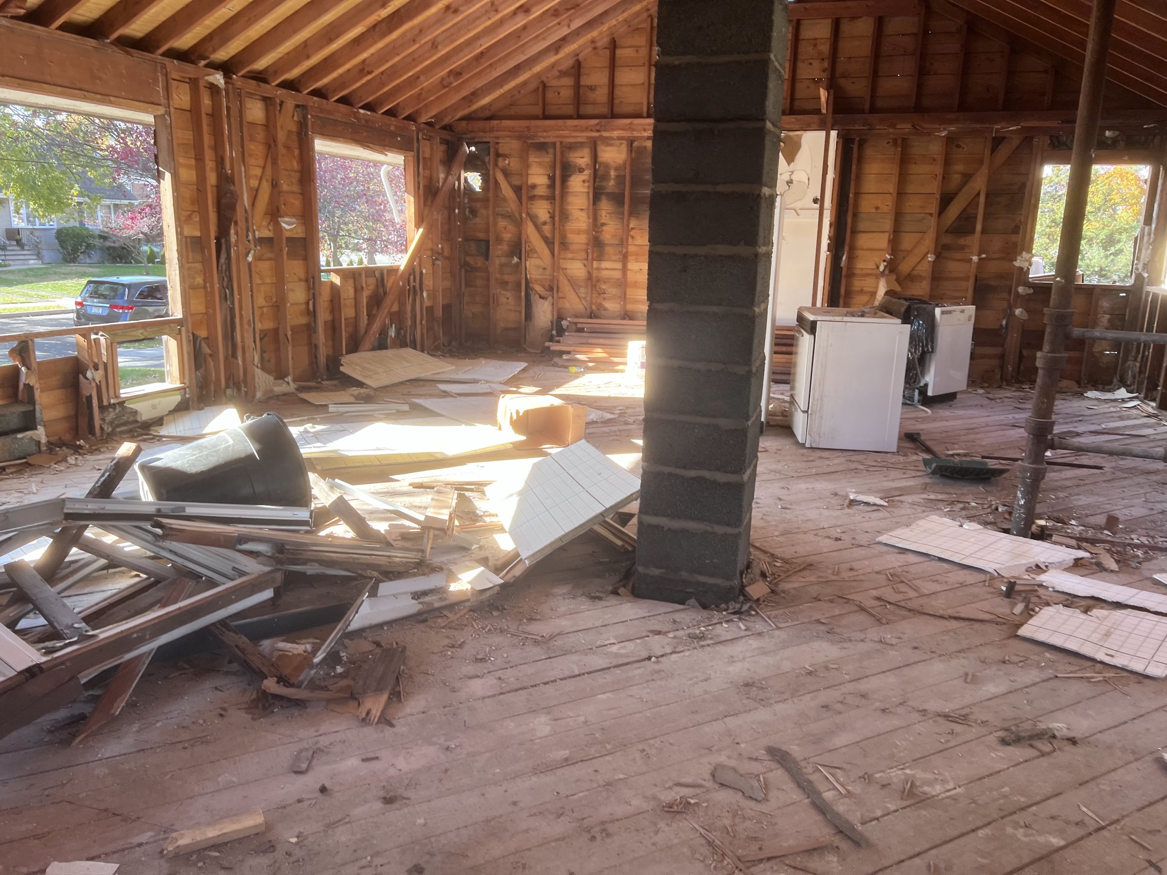 Interior taken back to the framing during a full gut, joists and studs exposed