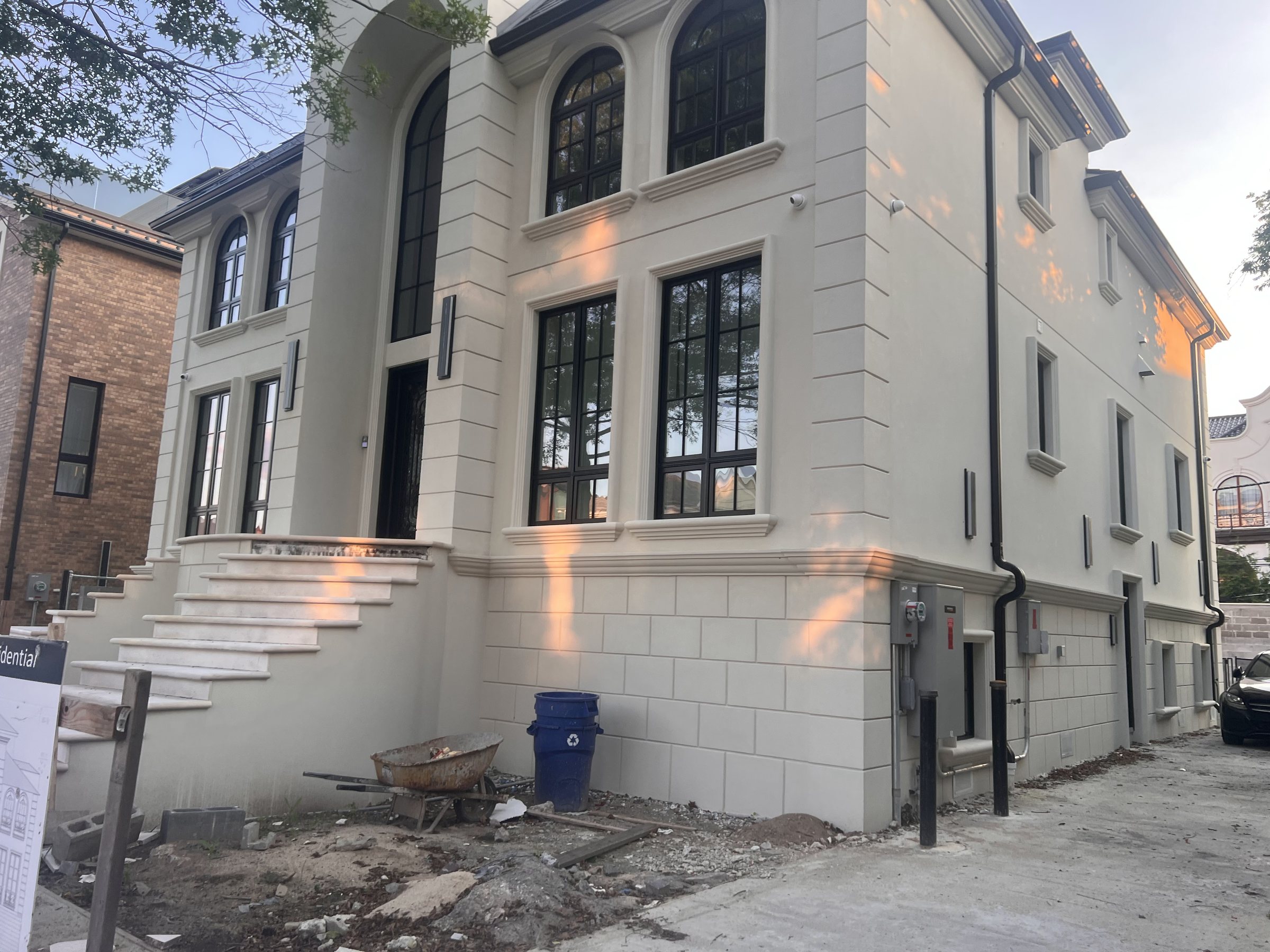 Townhouse exterior with arched windows and a rebuilt front stoop